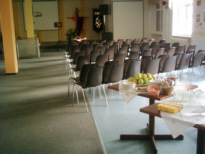 Lange Tische mit Stuhlreihen in einem Saal